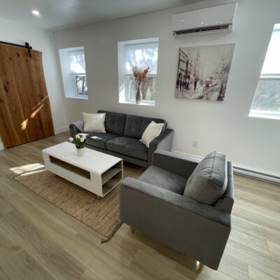 Seating area and sliding door in lifted basement renovation